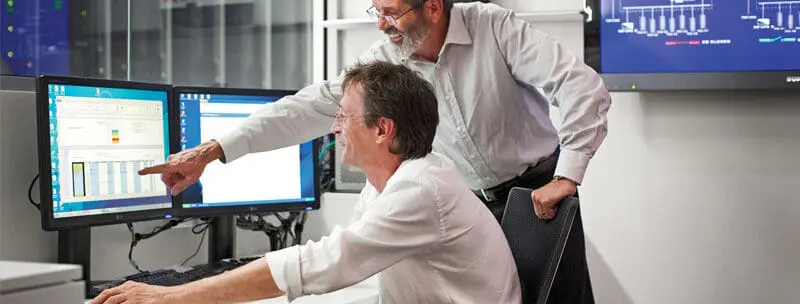 Two Engineers working at Data Centre Facility Sydney and looking at their computer screen.