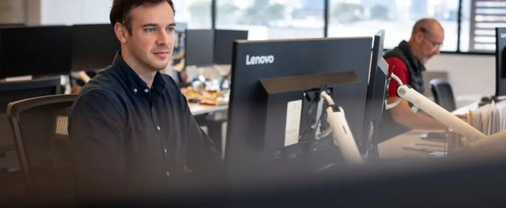 a person working at interactive pty looking at the computer doing work