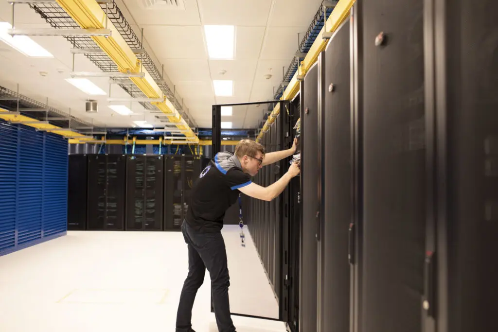 interactive technician looks at racks in data centre facility sydney