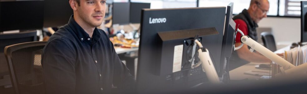 a person working at interactive pty looking at the computer doing work